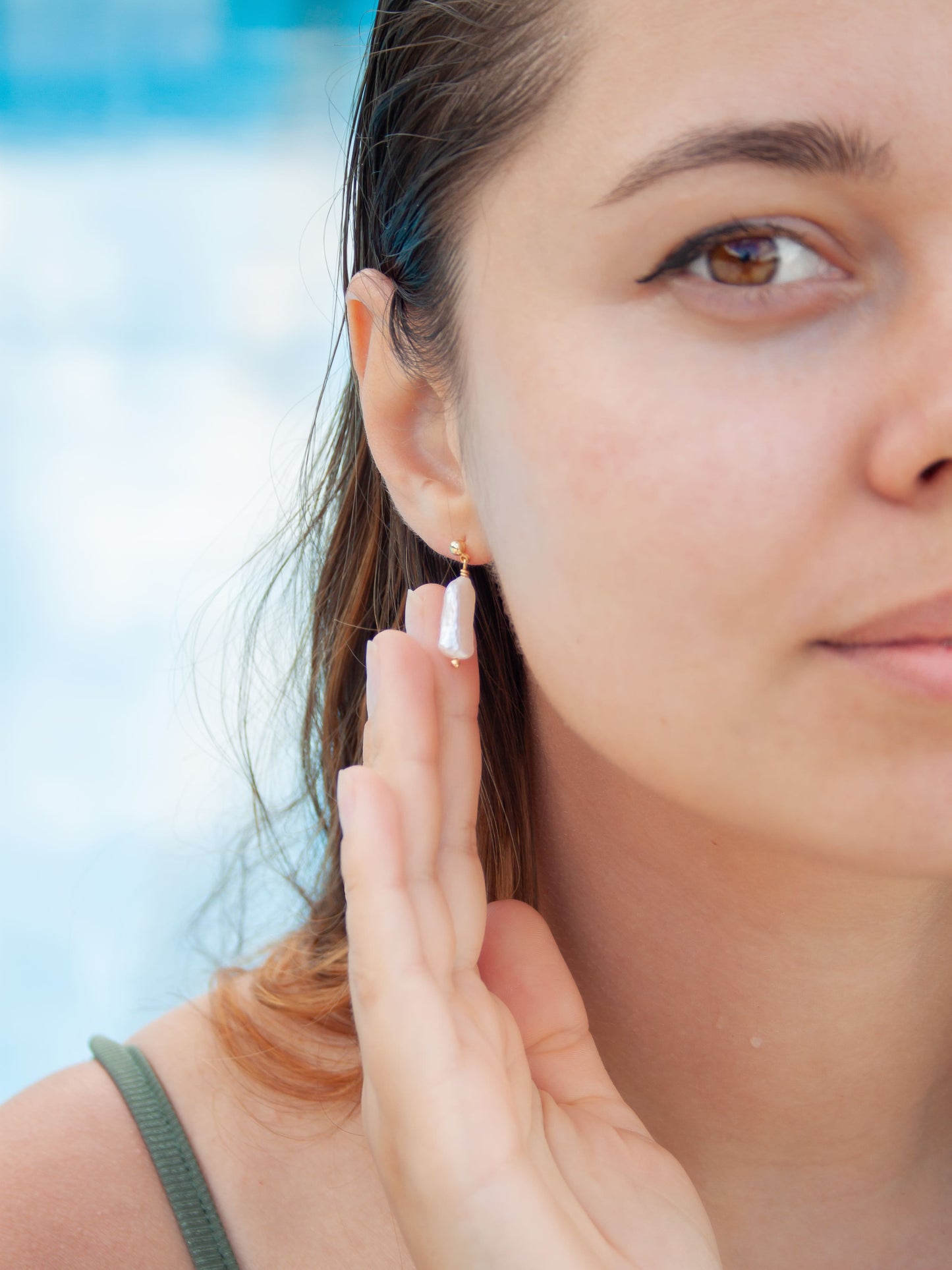 Woman wearing a small earring with a blurred background