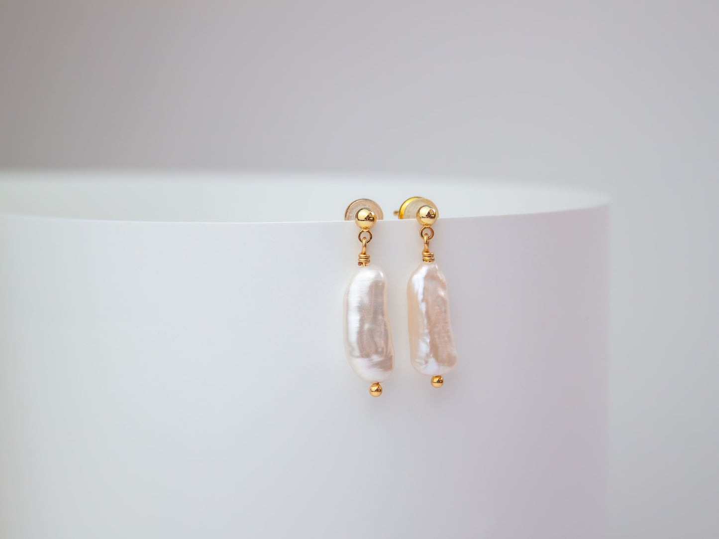 Pearl stud earrings on a white background