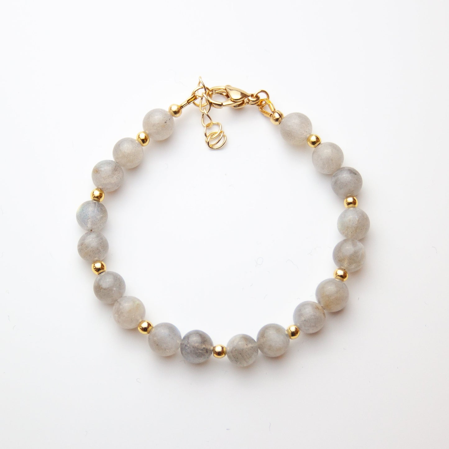 Moonstone bracelet with gold beads on white background