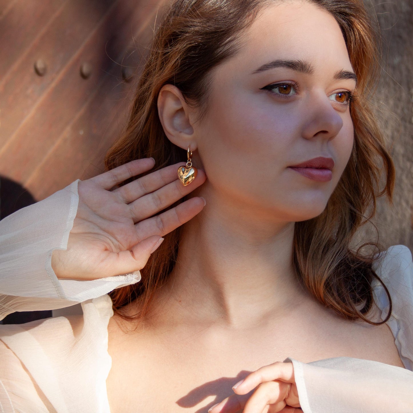 Gold puffy heart hoop earrings