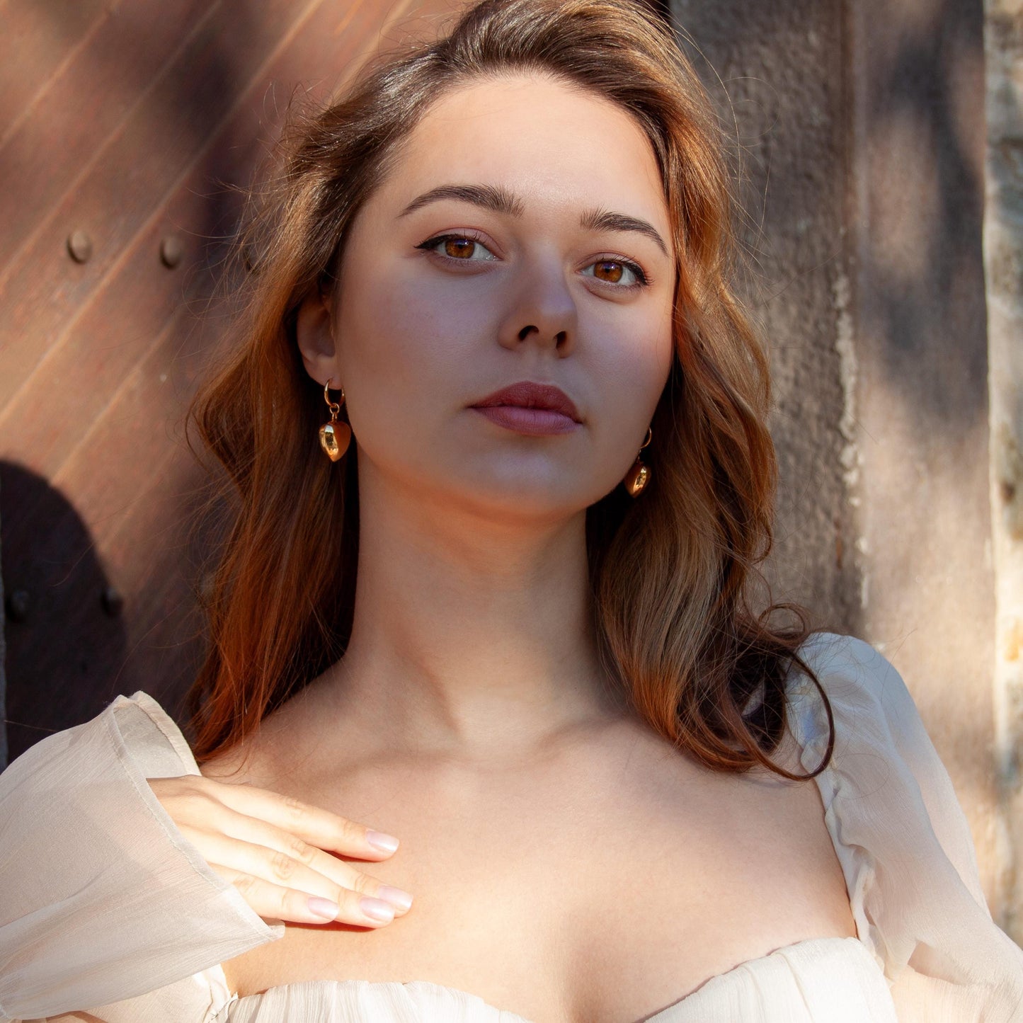 Gold puffy heart hoop earrings