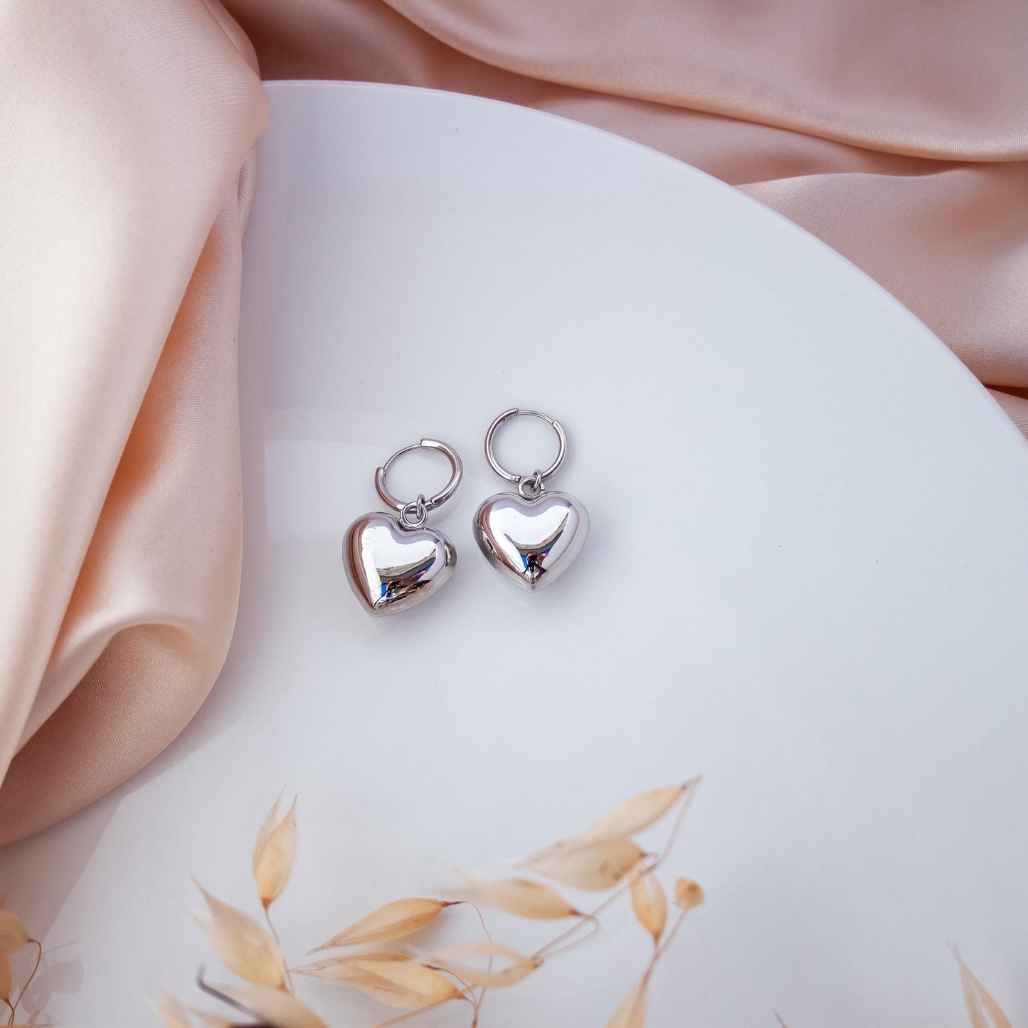Silver puffy heart hoop earrings