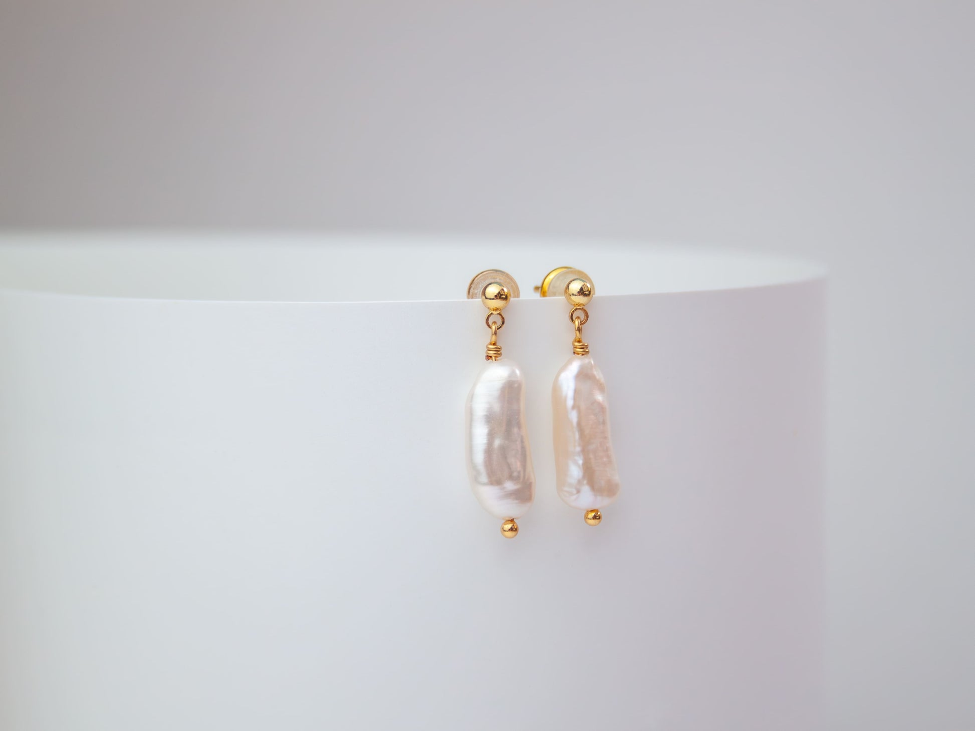 Pearl stud earrings on a white background
