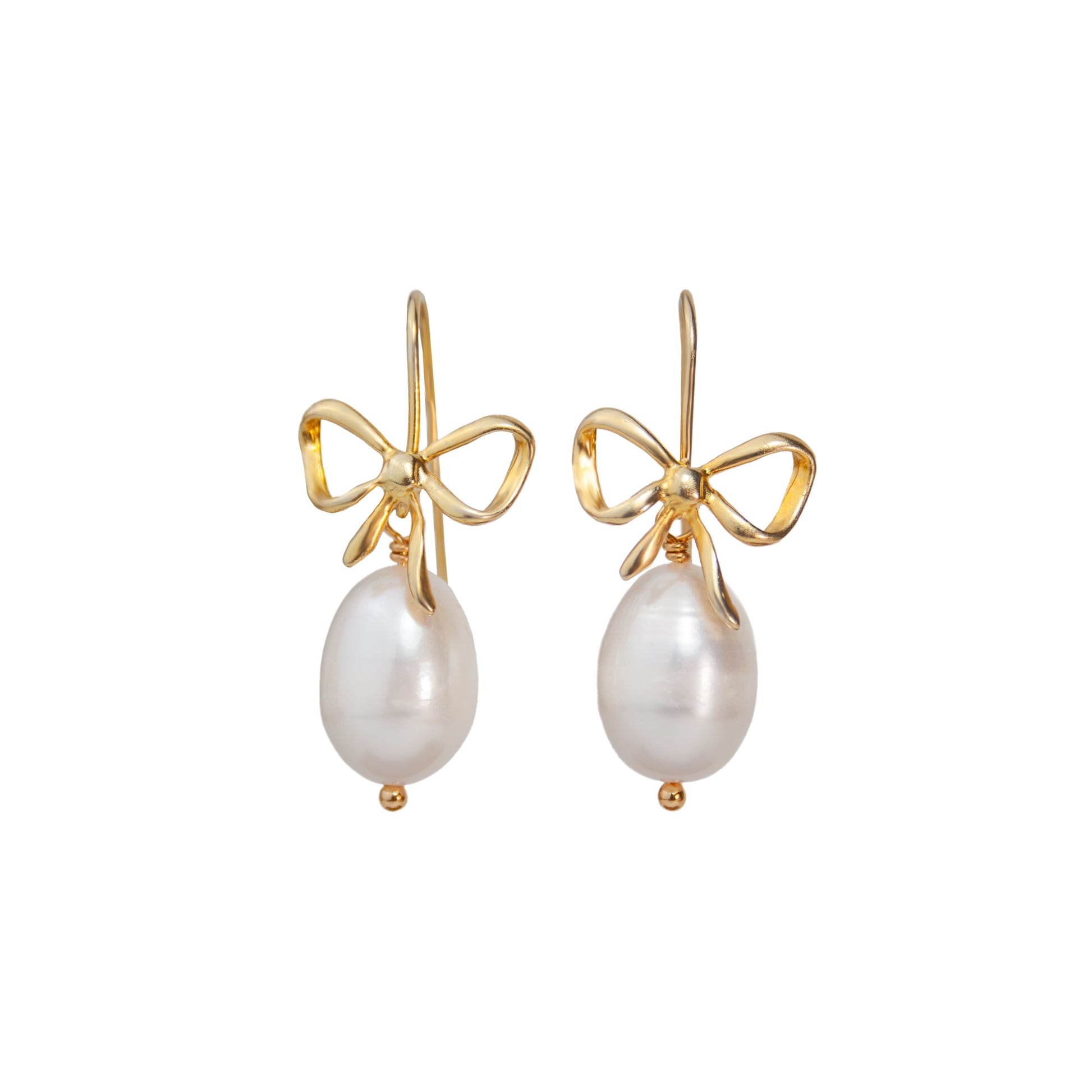 Gold bow earrings with pearl drops on a white background