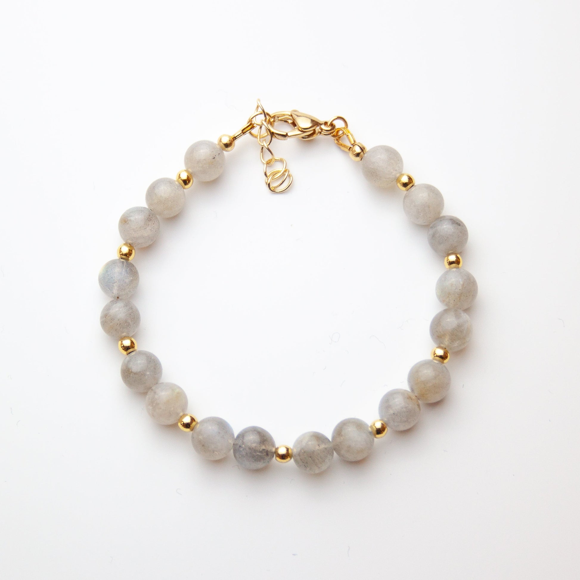 Moonstone bracelet with gold beads on white background